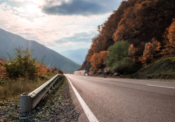 istock mountain road and sky with sunbeams in Georgia 1185457537
