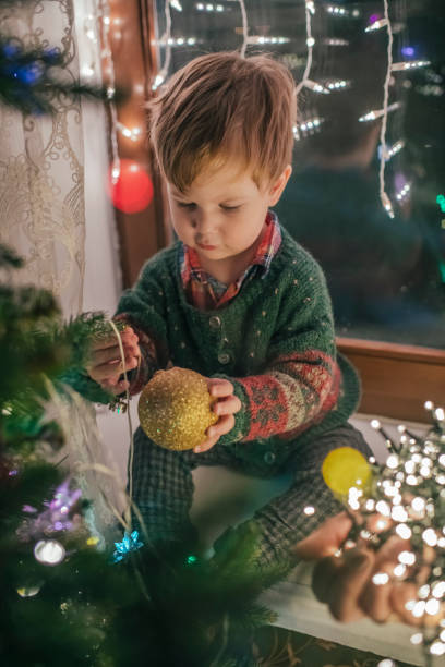 istock Family decorating Christmas tree at home 1185457550