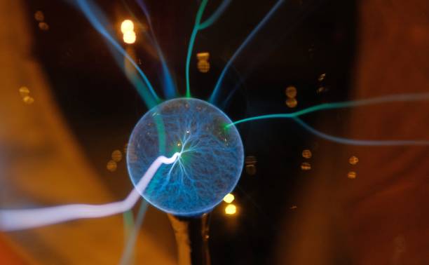istock Hand touching a plasma ball with smooth magenta-blue flames 1185458912