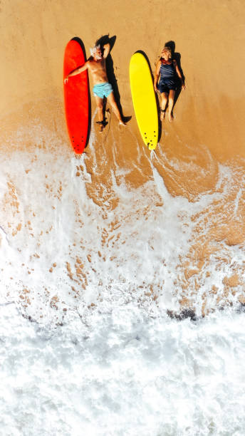 senior surfers - women sea cheerful surfing imagens e fotografias de stock