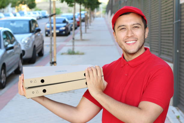 istock Ethnic guy delivering a pizza with a smile 1185464028