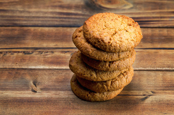 istock Stack of oatmeal cookies on wooden surface 1185464133