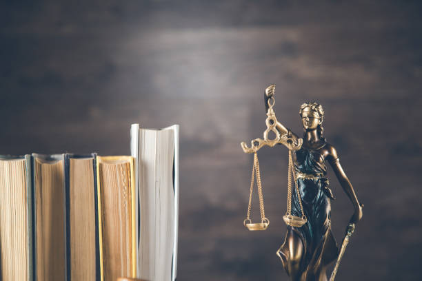 istock justice lady  and books on the dark background 1185464164