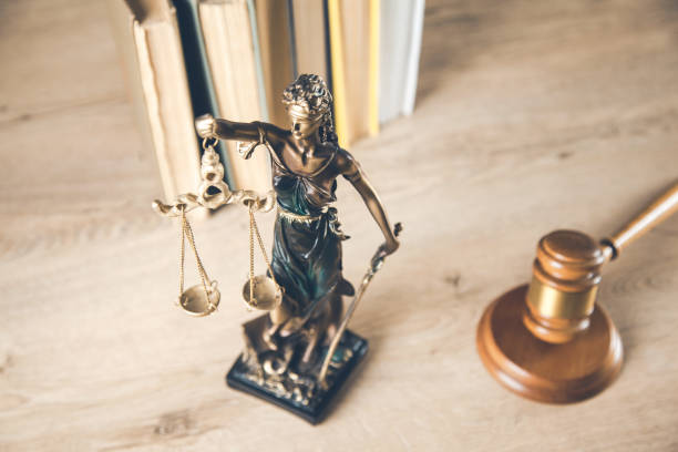 istock justice lady with judge and books on desk 1185464197