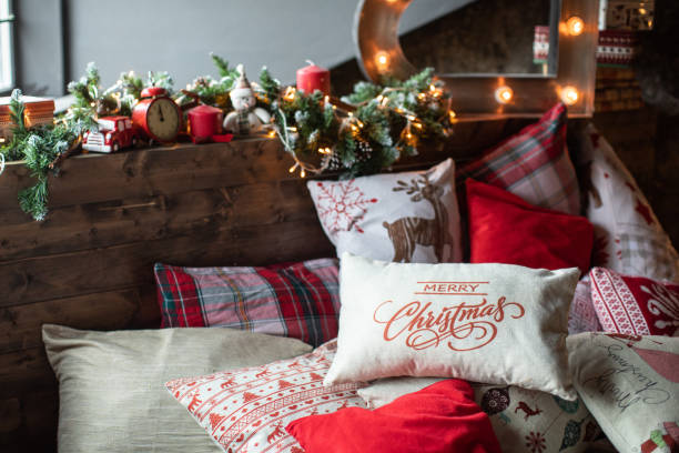 istock Cozy bed with Christmas pillows decorated with Christmas decor 1185464329