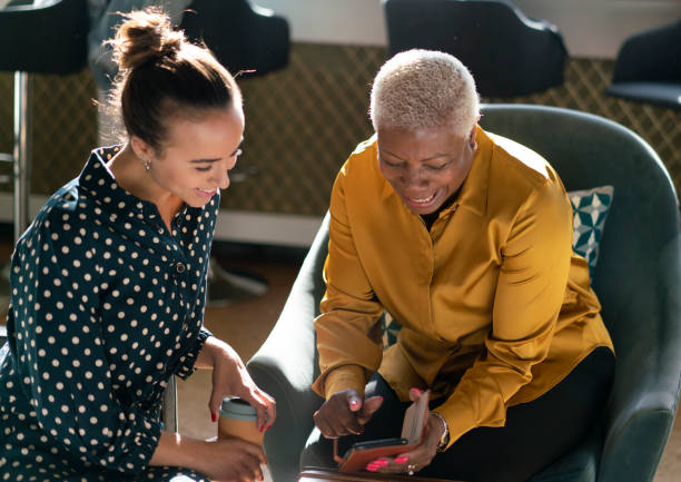 work colleagues sharing information during coffee break stock photo