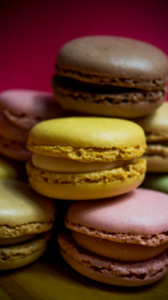 istock Colored macarons isolated on wooden dish, typical French dish 1185466970