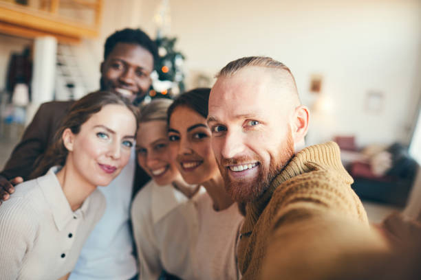 istock Young People Taking Selfie at Christmas Party 1185468234