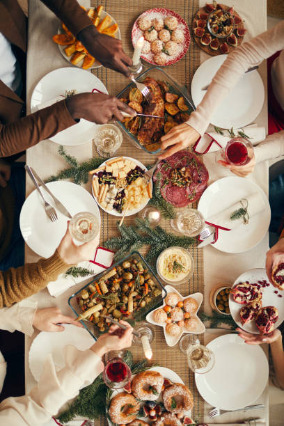 Christmas Feast Top View Above view background of people dining at festive Christmas table with delicious homemade food, copy space brunch photos stock pictures, royalty-free photos & images