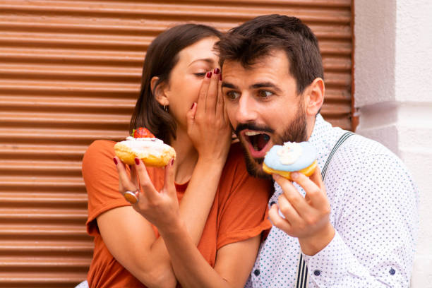 istock Woman telling secrets to her boyfriend. 1185469221