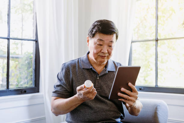 istock Senior man holding medication consults internet on digital tablet 1185469918