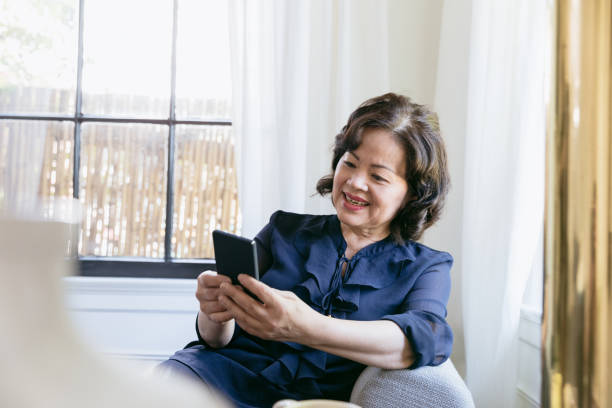 istock Woman leans back on couch and surfs the net 1185470058