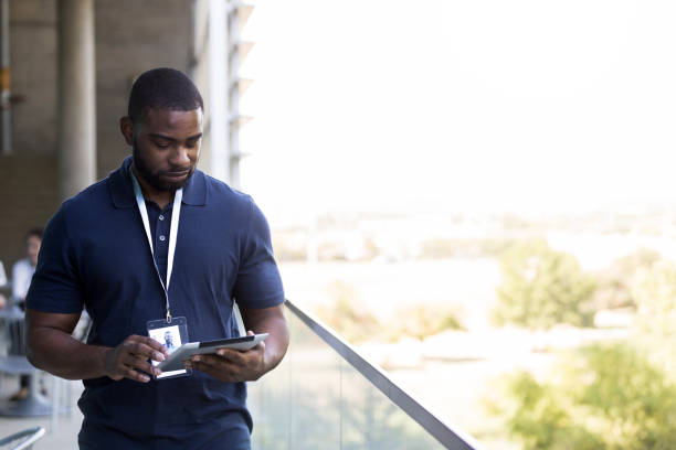 istock Walking along balcony, physical therapist reviews patient list on tablet 1185470252