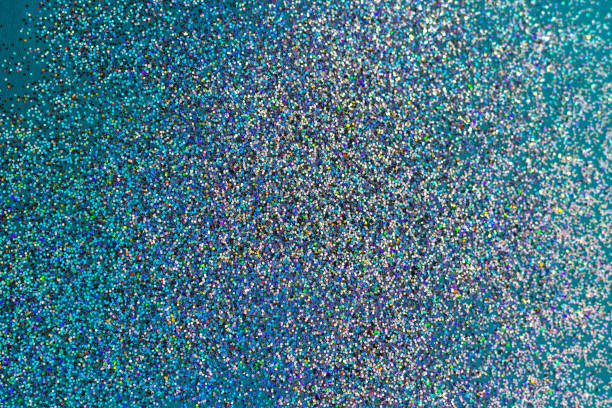 istock Multicolored holographic sparkles on a blue background. 1185470623