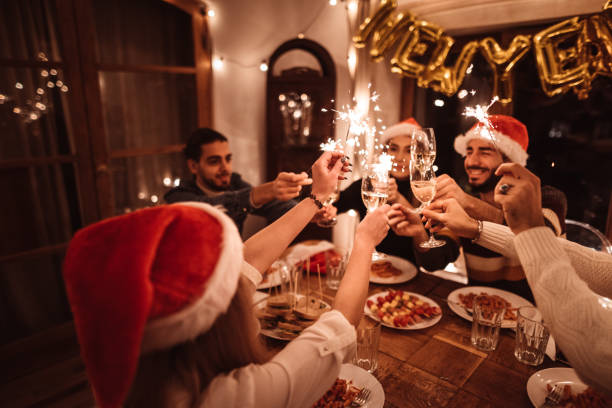 istock friends toasting at home for christmas 1185473416