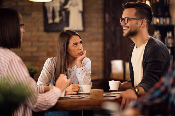 istock Group of friends talking while drinking coffee in a cafe,. 1185474121