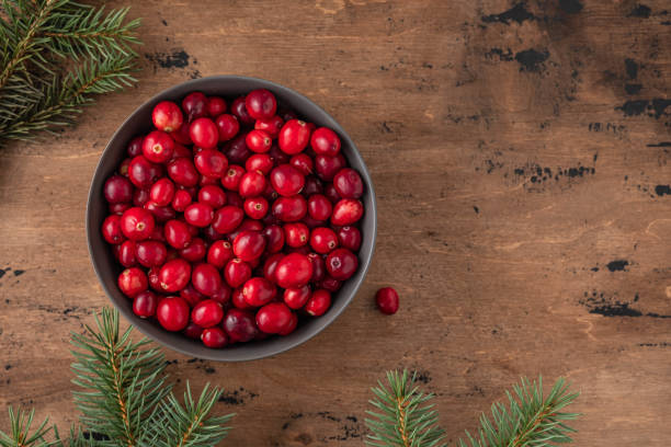 istock Cranberries in basket on wooden background. Copy space. 1185474324