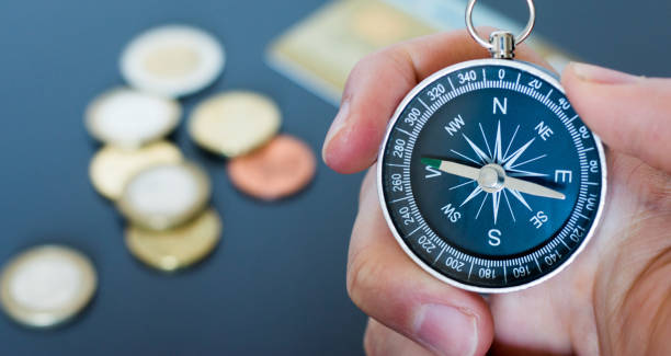 istock Innovation concept: Man is holding a compass in his hand, closeup cutout 1185474460