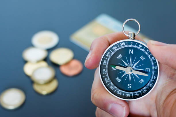 istock Innovation concept: Man is holding a compass in his hand, closeup cutout 1185474482