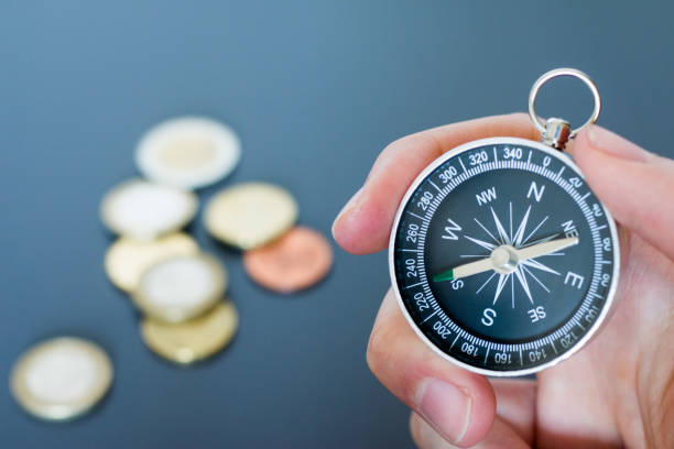 istock Innovation concept: Man is holding a compass in his hand, closeup cutout 1185474490