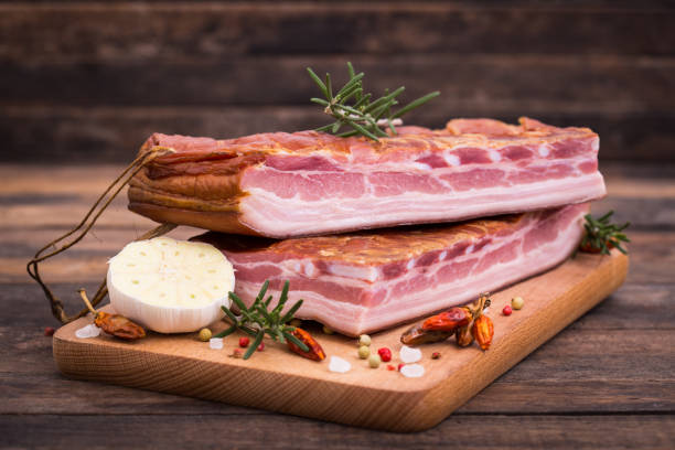 istock Homemade smoked bacon on wooden board 1185475882