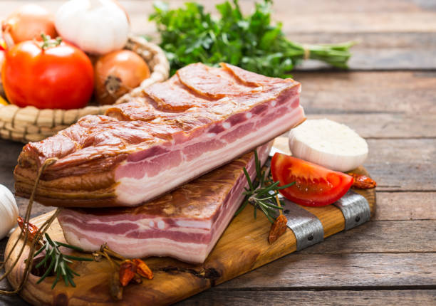 istock Homemade smoked bacon on wooden board 1185475902