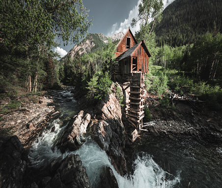 abandoned cabin with waterfall in colorado