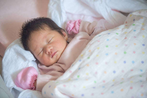 istock sleeping newborn baby Covering cloth 1185477196