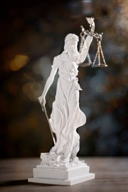 istock Statue of Lady Justice. Vertical image with soft focus and bokeh background. 1185477337