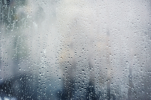 Rainy background, rain drops on the window, autumn season backdrop, abstract textured wallpaper.