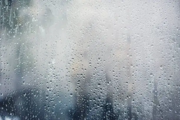 Photo of Rainy background, rain drops on the window, autumn season backdrop, abstract textured wallpaper