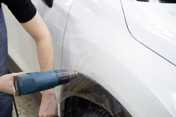 istock Installation of protective film for car paint. 1185478667