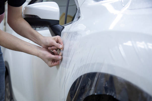 istock Installation of protective film for car paint. 1185478680