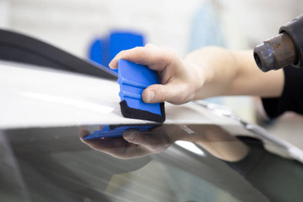 istock Installation of protective film for car paint. 1185478695