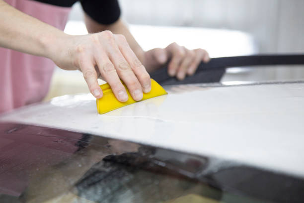 istock Installation of protective film for car paint. 1185478703