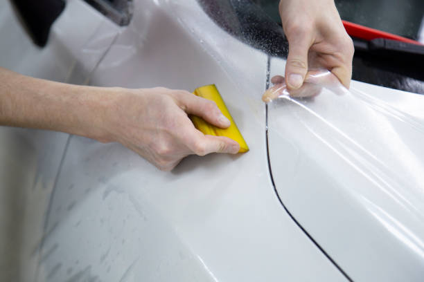 istock Installation of protective film for car paint. 1185478707