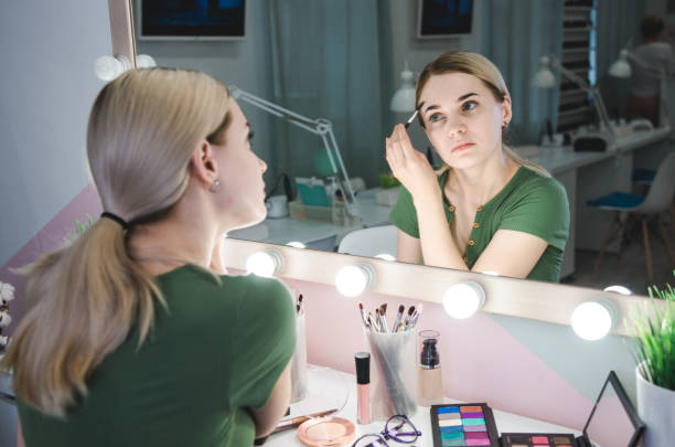 istock Young beautiful woman making make-up 1185482670