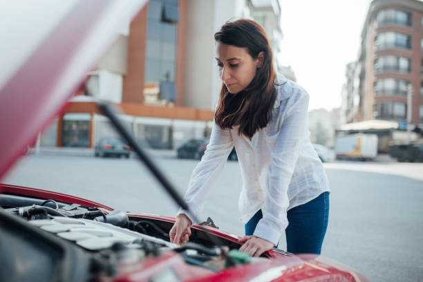 istock Woman trying to fix the car 1185487197