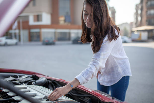 istock Woman trying to fix the car 1185487750
