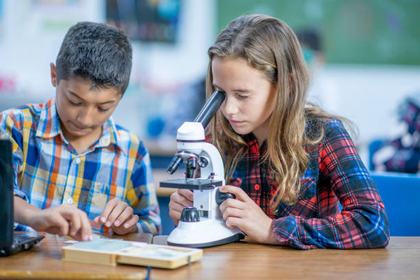 istock Multi-Ethnic Group of Students Working With a Microscope stock photo 1185489503