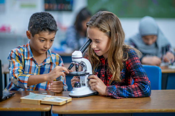 istock Multi-Ethnic Group of Students Working With a Microscope stock photo 1185489514