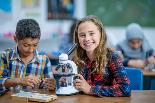 istock Multi-Ethnic Group of Students Working With a Microscope stock photo 1185489524