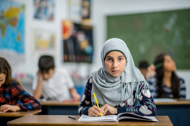 istock Afghan Elementary School Girl Writing in Class stock photo 1185489534