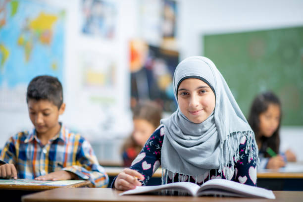 istock Afghan Elementary School Girl Writing in Class stock photo 1185489550