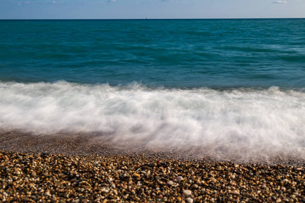 istock Bright Sunny seascape on a pebble beach. 1185494397