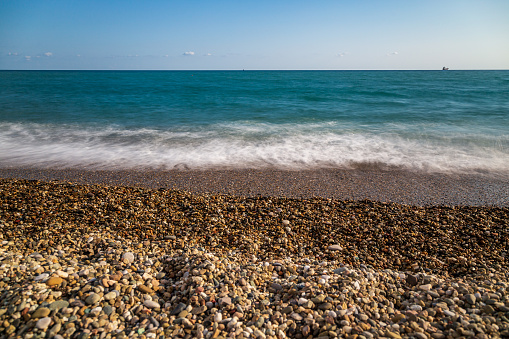 Close-up of large and small colored stones by the sea in Turkey.