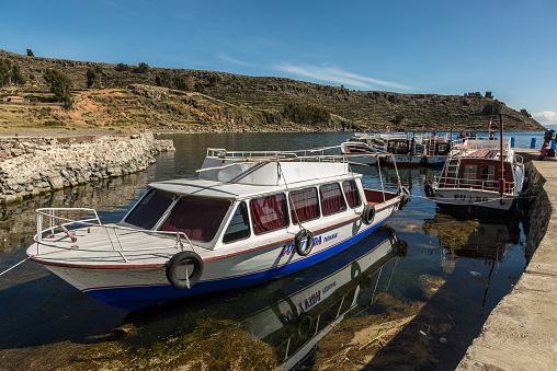 Puno, Peru - Circa 2014: Motorboats close to Amantani Island circa 2014 in Puno region, Peru