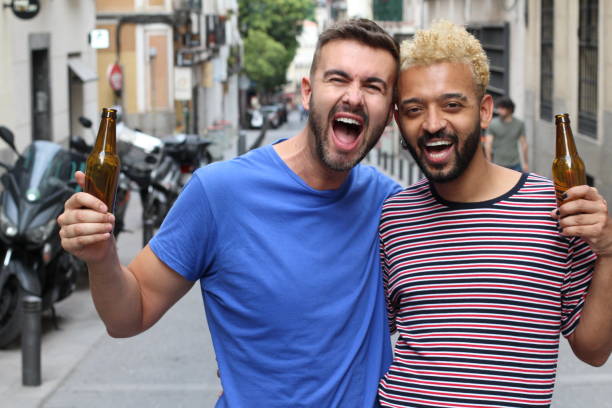 istock Interracial male friends enjoying a beer 1185495585