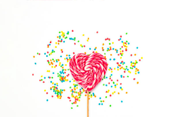 istock Heart Lollipop and multi coloured sweets on a gently white backg 1185495779