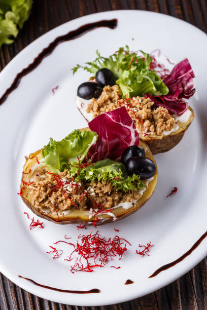istock Twice baked potato stuffed with tune on white plate 1185497561